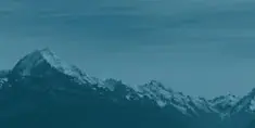 A mountain range with snow on it's sides.