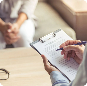 Professional conducting an interview or consultation with a clipboard in hand.